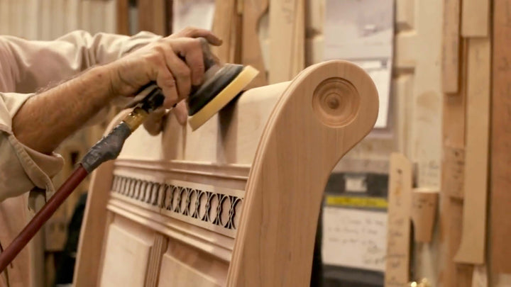 Amish craftsman making a solid wood bed