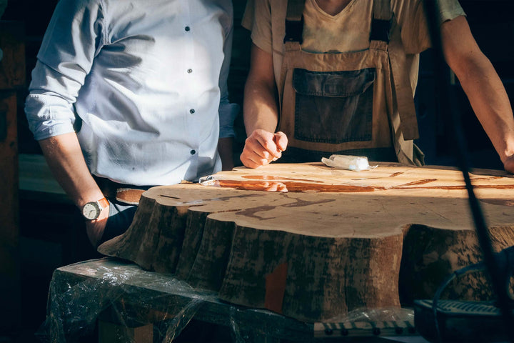 Amish furniture specialist meeting with Amish craftsman with solid wood trunk