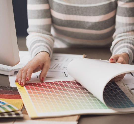 Furniture customer looking at color options book