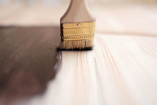 Closeup of wood furniture being finished with stain